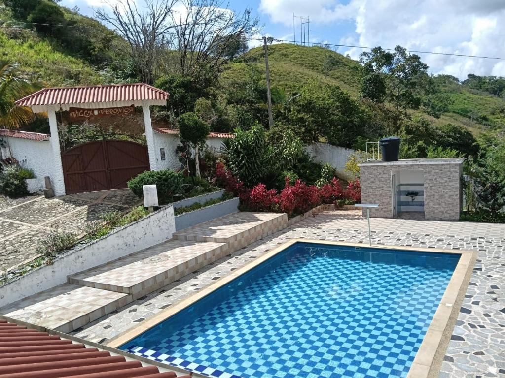 a swimming pool in the yard of a house at villa veronica in Sasaima