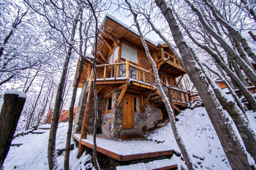 a tree house in the woods in the snow at Patagonia Villa in Ushuaia
