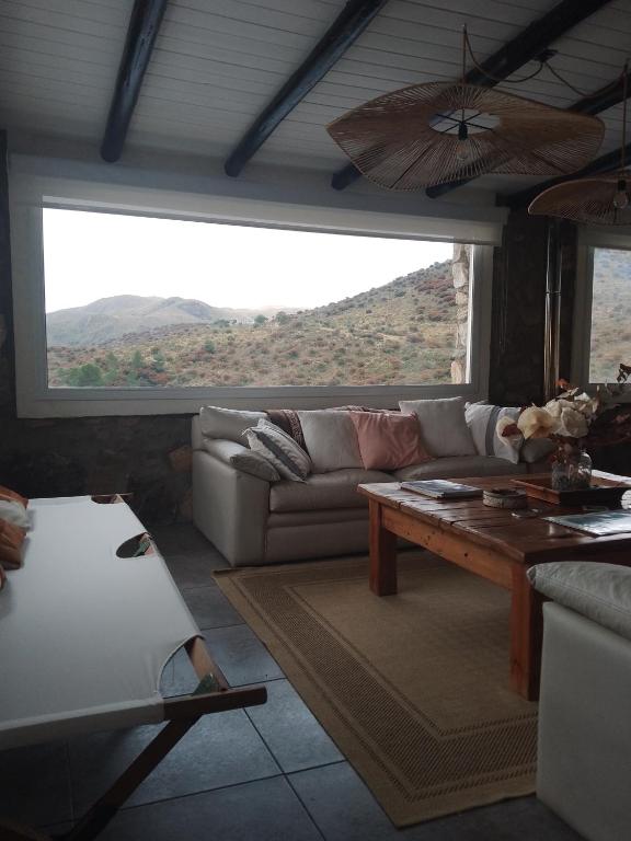 a living room with a couch and a table at Oveja Mansa in La Cumbre