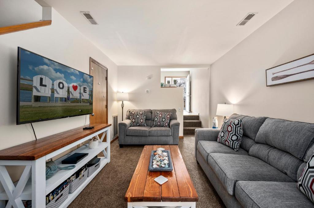 a living room with a couch and a tv at Fishhook Hideaway in Chincoteague