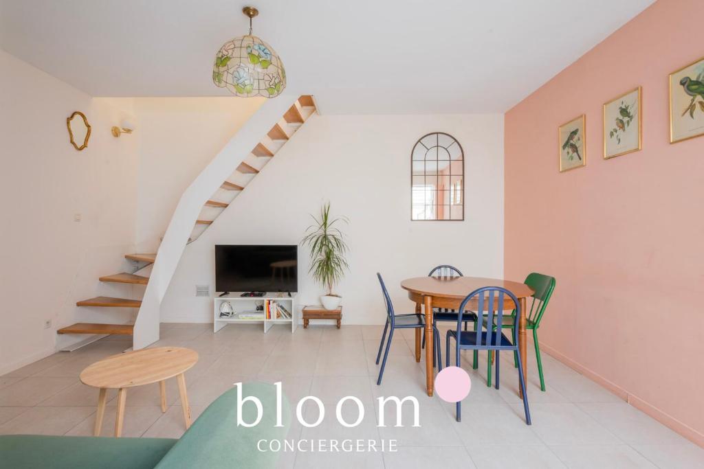 a dining room and living room with a table and chairs at La maison de C Moench in Nancy