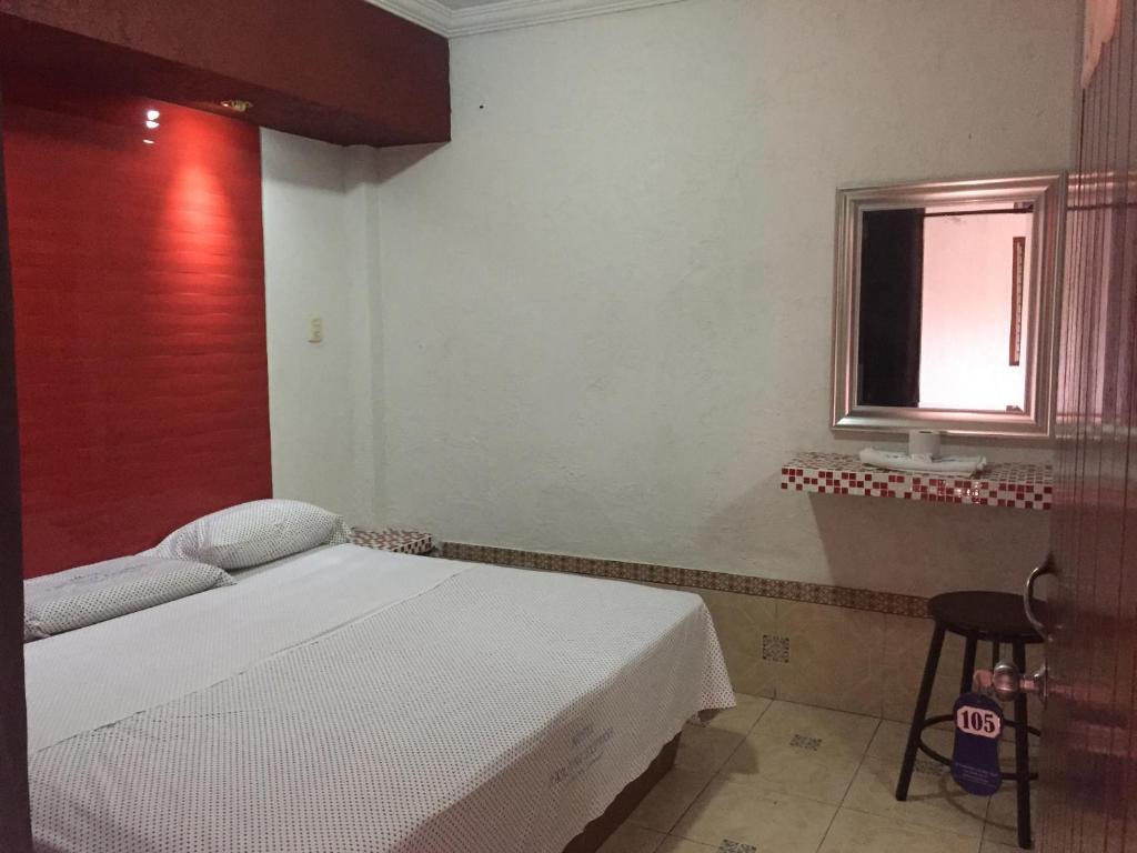 Postel nebo postele na pokoji v ubytování Hotel Paraiso Express