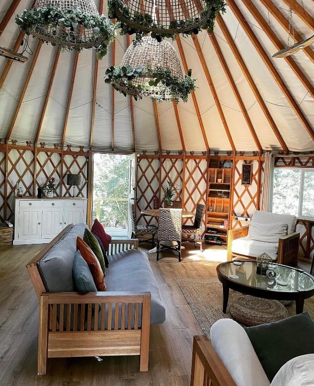 a living room with a couch in a yurt at Yurt - The Spinney in Faringdon