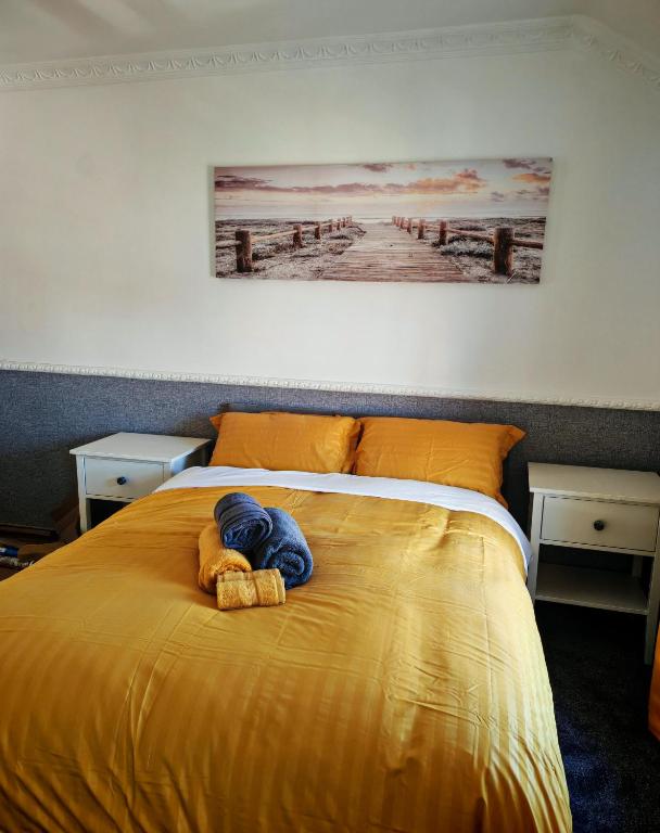 a yellow bed with a stuffed animal on it at Phoenix in Derry Londonderry