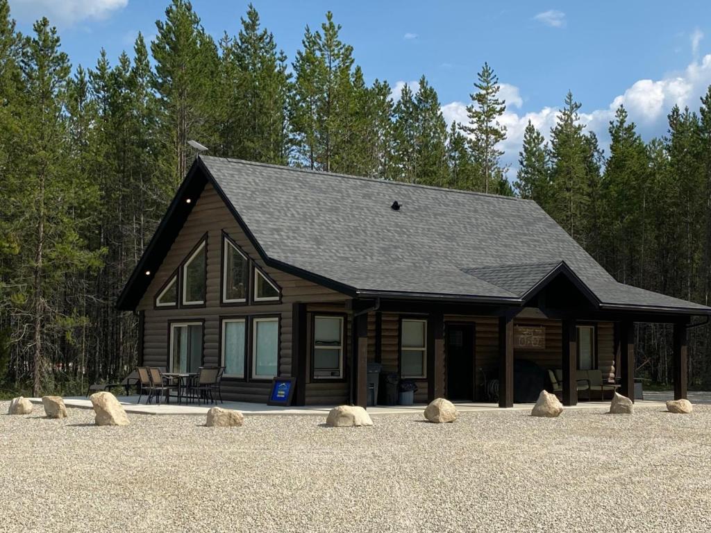 a log cabin with rocks in front of it at The Alpine Cabin in Valemount