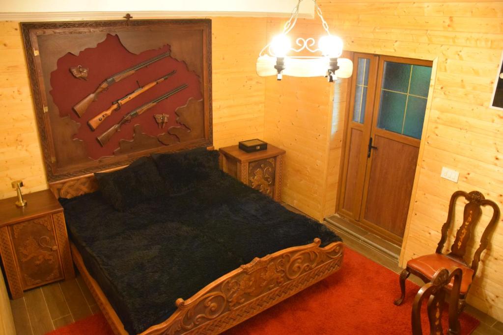 a bedroom with a wooden bed in a room at Komitski Konak & Spa in Plešanci