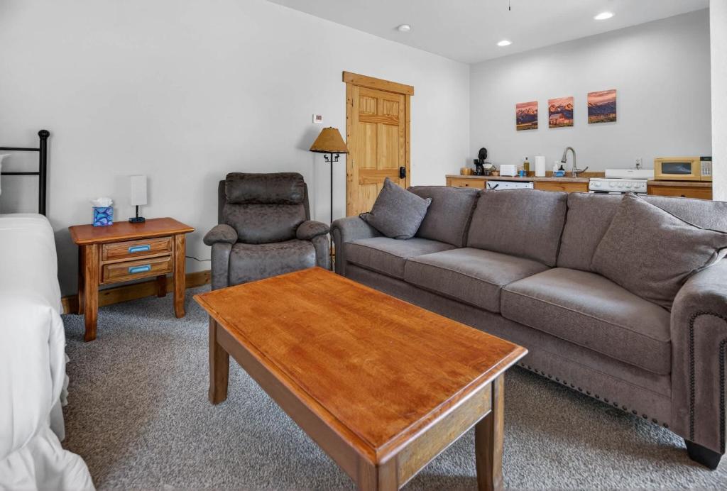 a living room with a couch and a coffee table at 1BR Mountain View Studio with Fireplace Deck Views in Fort Collins