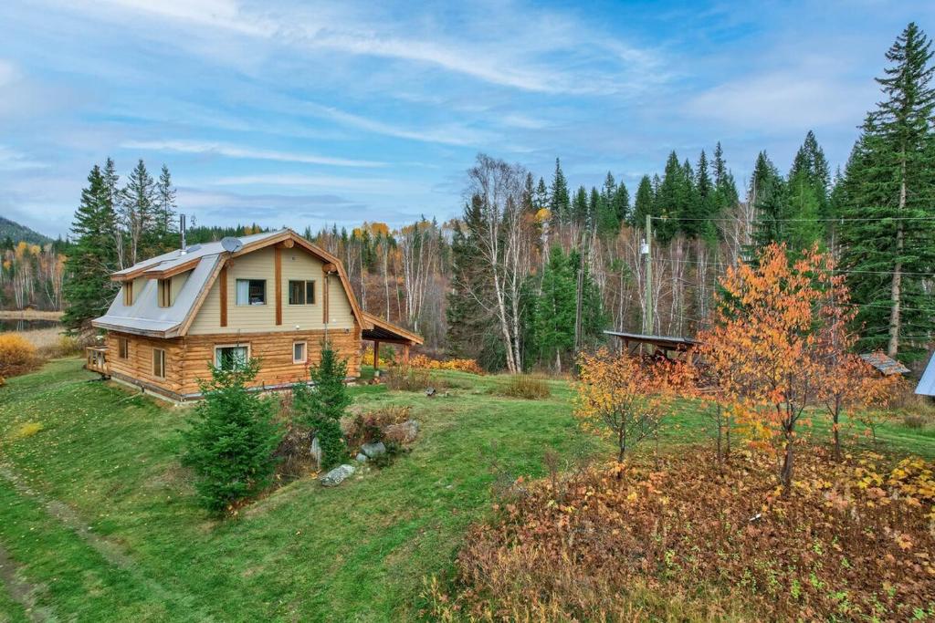 a house in the middle of a field at Cabin on Private 8-acre Lake in Clearwater