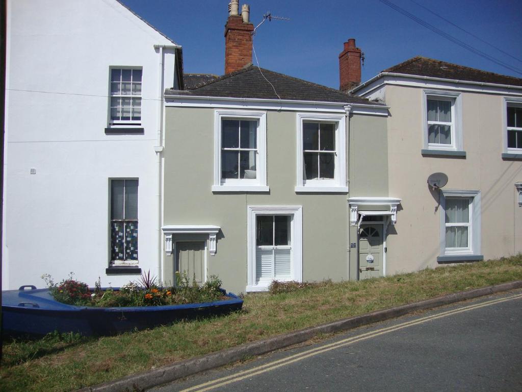 a white house on the side of a street at Shipwrights Cottage in Teignmouth