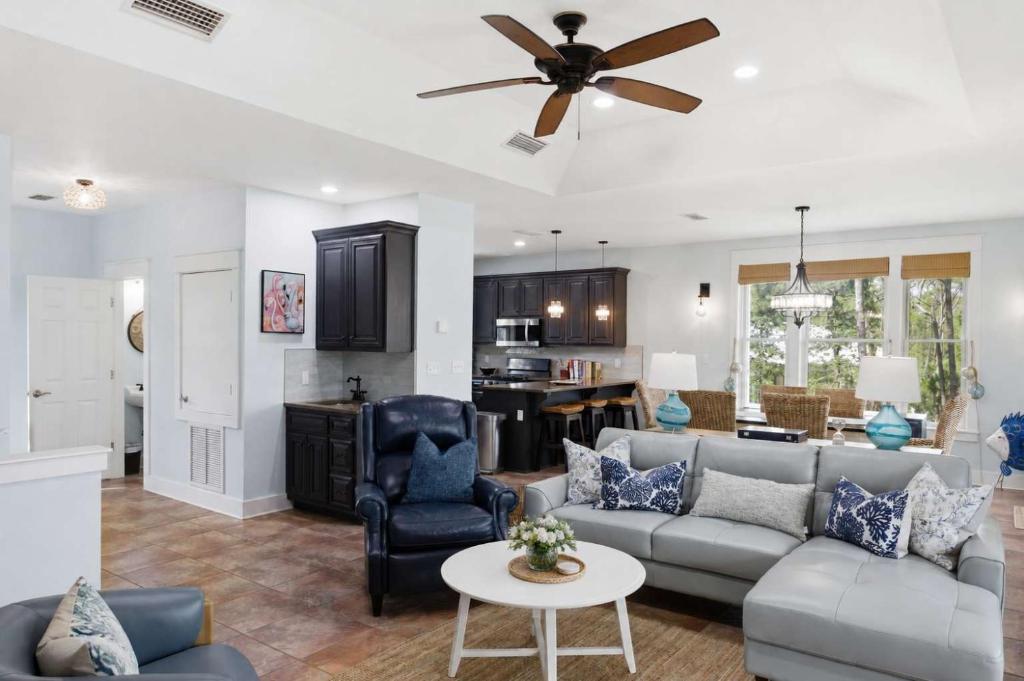 a living room with a couch and a ceiling fan at St George Island Bay Front Pool in St. George Island