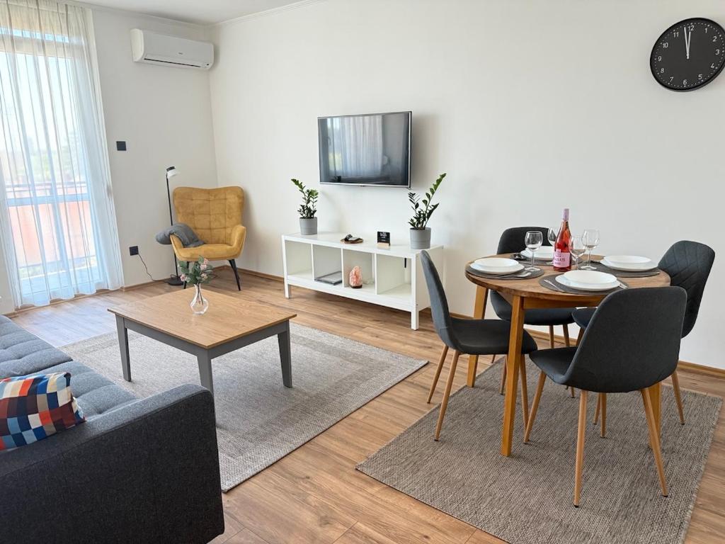 a living room with a table and a couch at Radnóti Apartman Győr in Győr