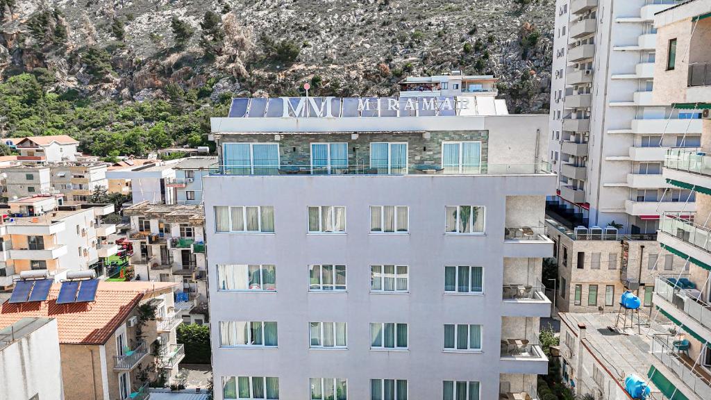a white building with a sign on top of it at MiraMar Hotel in Shëngjin