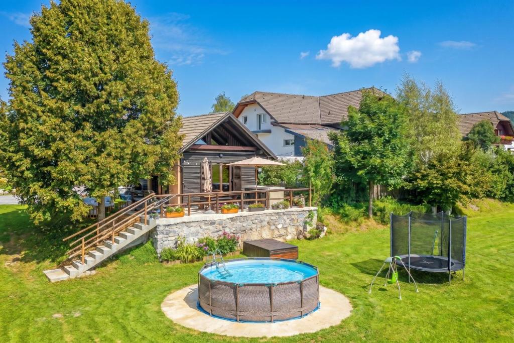 a backyard with a swimming pool and a house at Kraševec Lodge with Garden & Pool - Happy Rentals in Velike Bloke