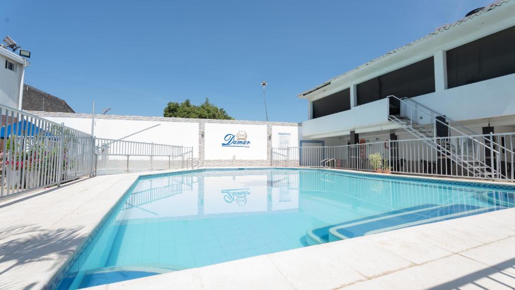 a swimming pool in front of a building at Damar Hotel Collection Valledupar in Valledupar