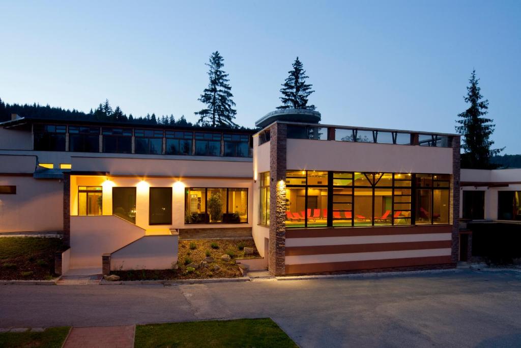 a large white house with a lot of windows at Holiday Park Orava - Hotel Orava in Dolný Kubín