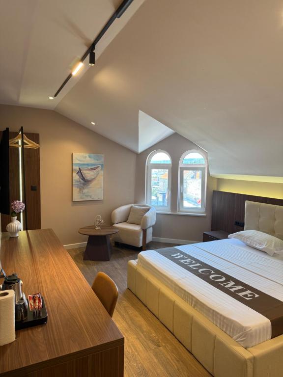 a hotel room with a large bed and a desk at NOMA Rooms Murter in Murter