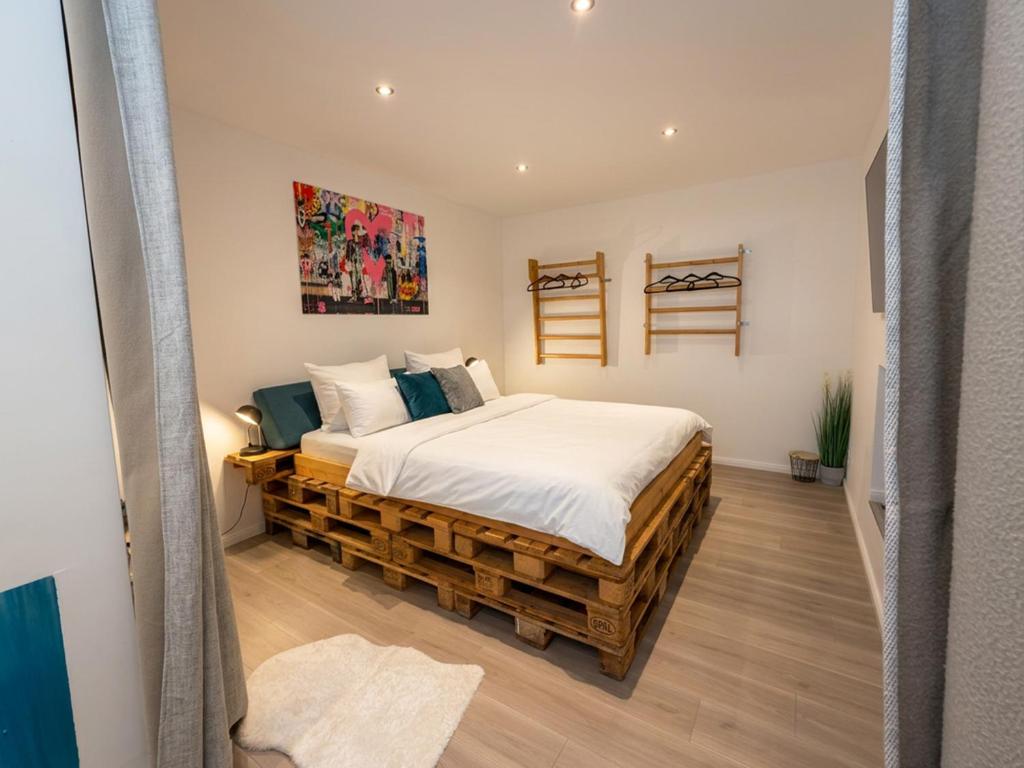 a bedroom with a bed made out of logs at Apartment Jonte im Dangaster Nest in Varel