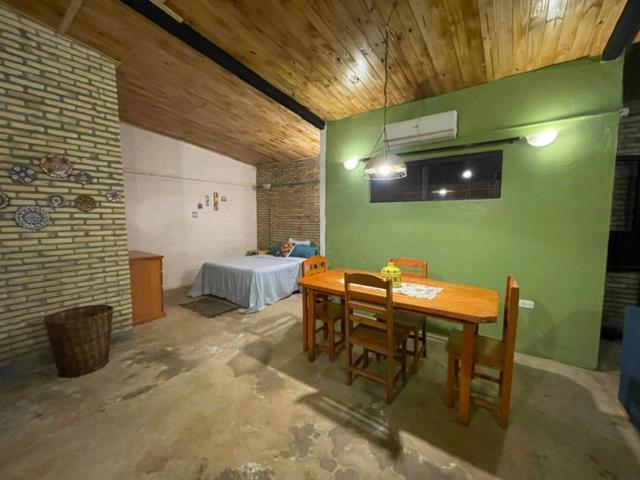a room with a table and chairs and a bed at Monoambiente Privado in Luque