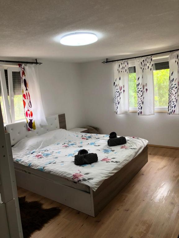 a bedroom with a bed with two stuffed animals on it at Villa ADUSHI Nashec in Prizren
