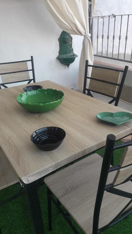 a wooden table with two green bowls on it at Casa Frida in Solanas