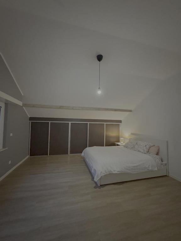 a white bedroom with a bed and a white ceiling at Dressing vibe in Ettelbruck