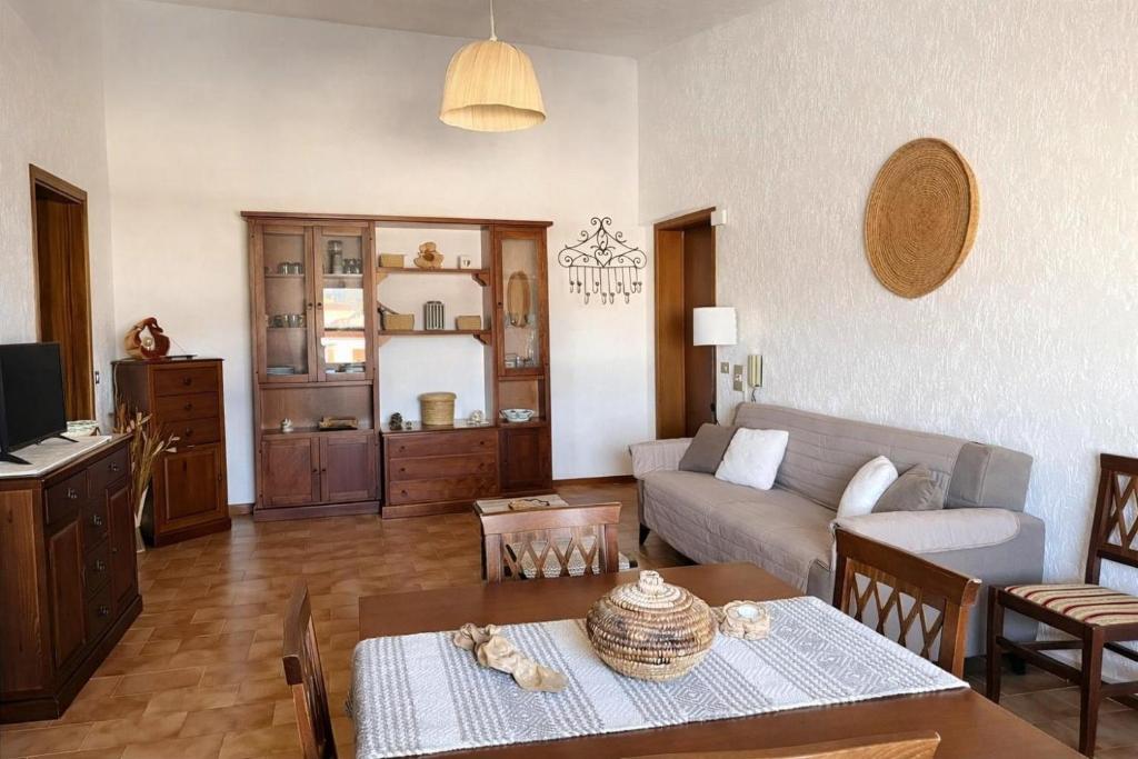 a living room with a couch and a table at Domo e Mare in Valledoria