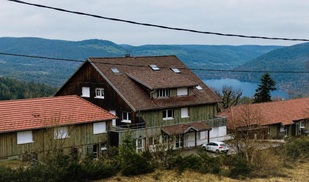 a group of houses with mountains in the background at Evasion Gérardmer in Gérardmer