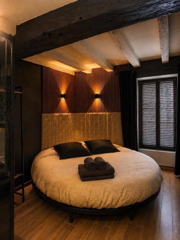 a bedroom with a large bed with two towels on it at PopCorn&Netflix in Bourges