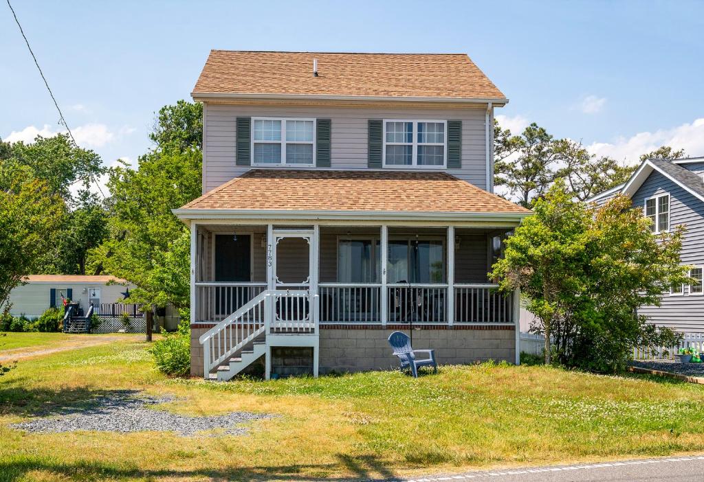 a house with a porch and a lawn at Lighthouse Overlook in Birch Town
