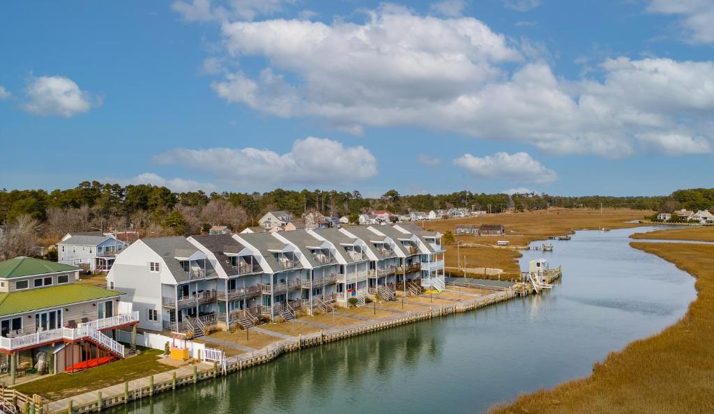 a group of buildings next to a river at Lighthouse Pointe in Birch Town
