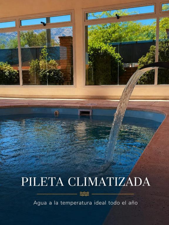 a water fountain in front of a building at El Cantar de los Pajaros in Merlo