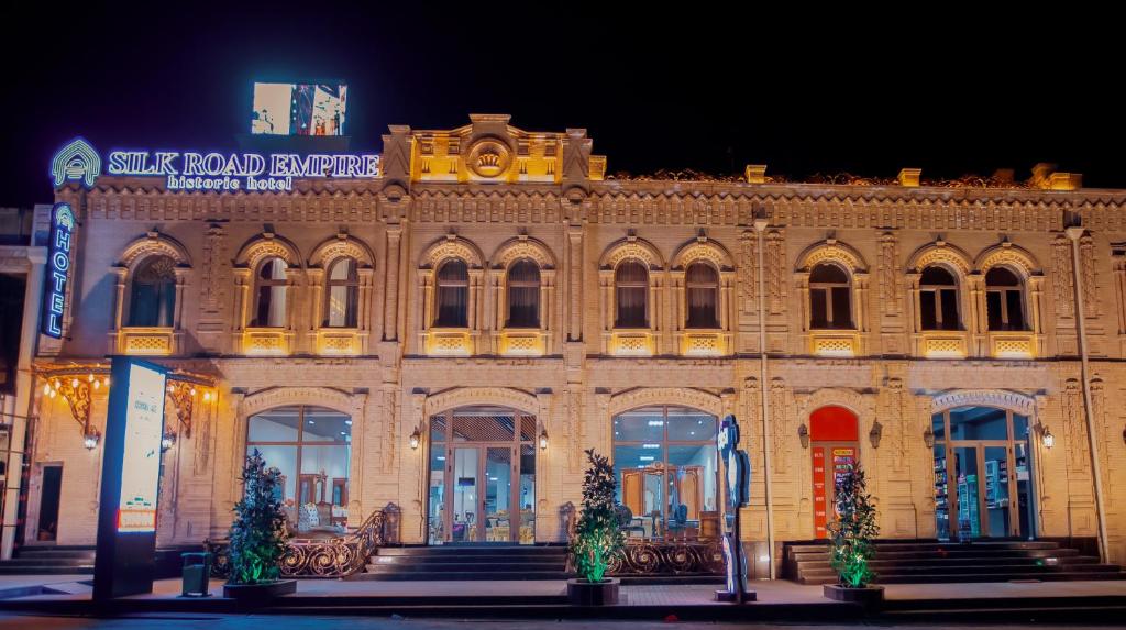 a large building with christmas trees in front of it at Silk Road Empire in Samarkand
