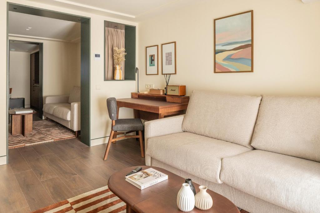 a living room with a couch and a table at POSTCODE Chueca in Madrid