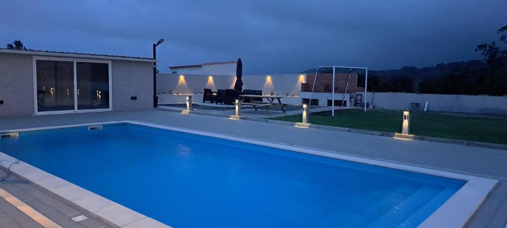 a swimming pool in the backyard of a house at 3BL Retreat - Escape & Poolparty in Praia da Vitória