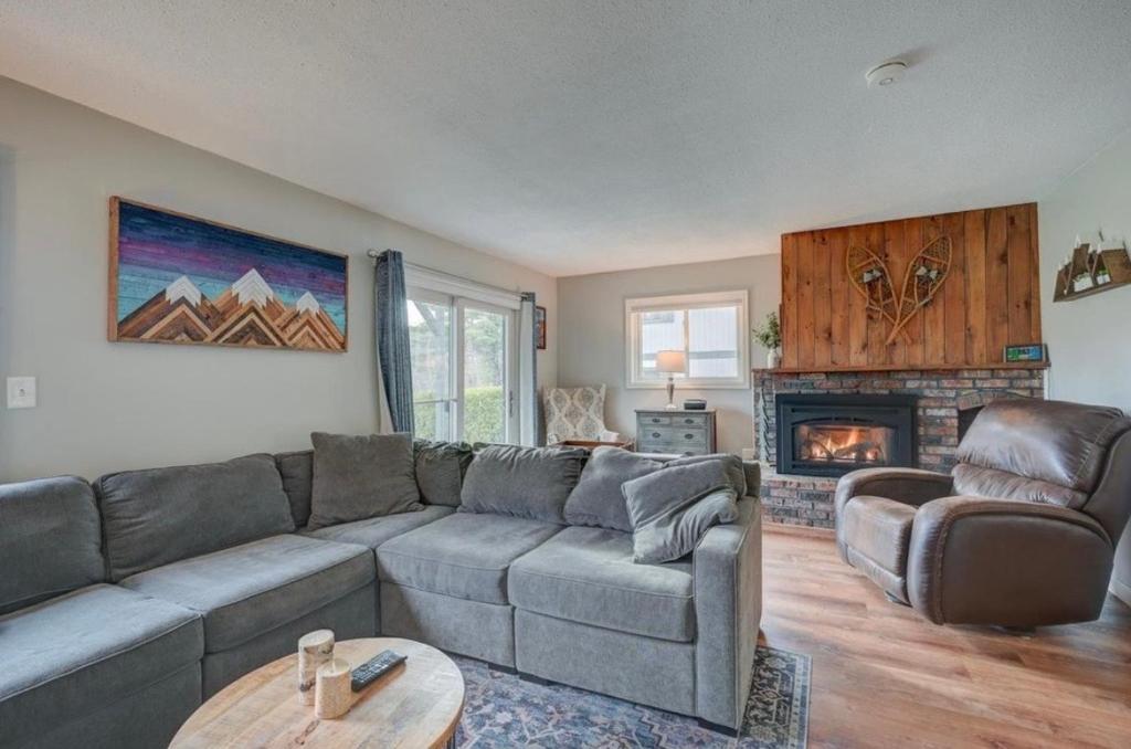 a living room with a couch and a fireplace at Central White Mountains Retreat in Bartlett