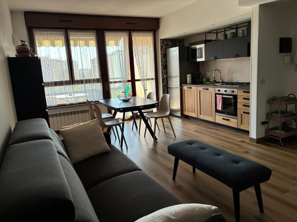 a living room with a couch and a table at Humanitas & Forum - CASA TUA Housing in Rozzano