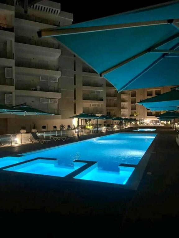 a swimming pool with blue lights in a building at Appartement S2 résidence costa '0751' 8402'79 fr in El Ahmar