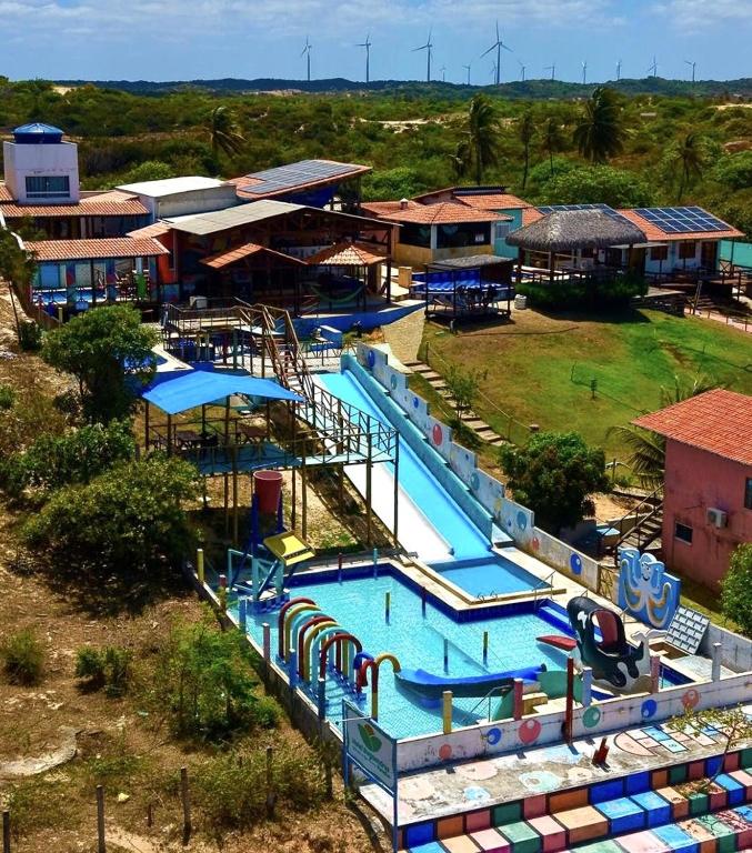 an aerial view of a large swimming pool with slides at Pousada Bugaendrus in Touros