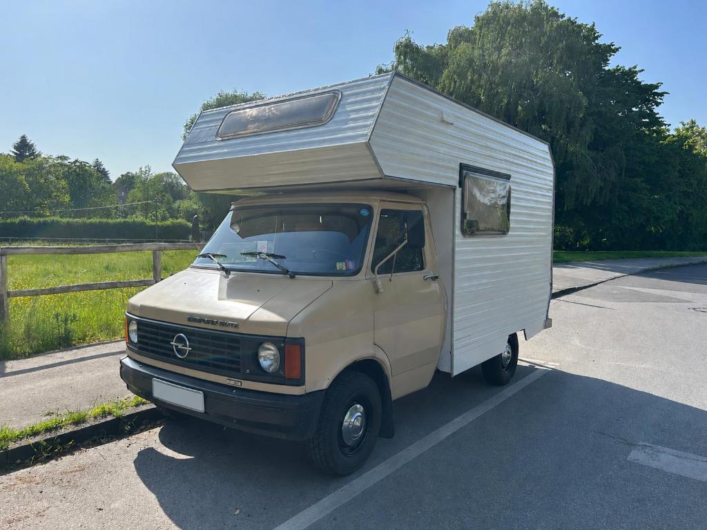 a small camper van parked in a parking lot at Charmantes Oldtimer Wohnmobil in Aachen