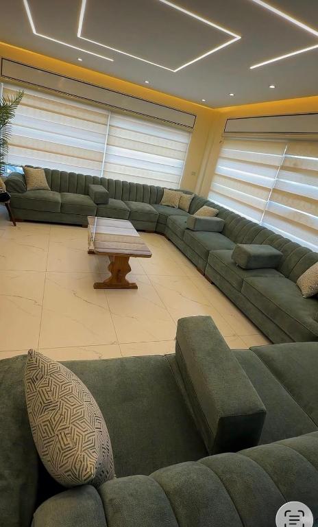 a large living room with a couch and a table at مزرعة اننتارا in Amman