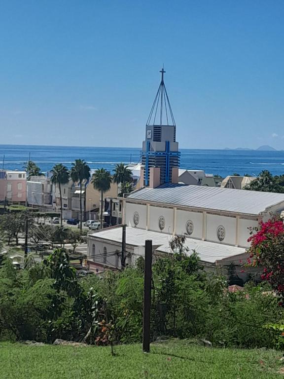 a large building with a tower on top of it at Bungalow vue sur mer in Sainte-Anne