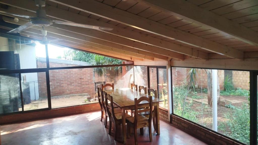 a dining room with a table and some windows at Rincón de Esperanza in Puerto Esperanza