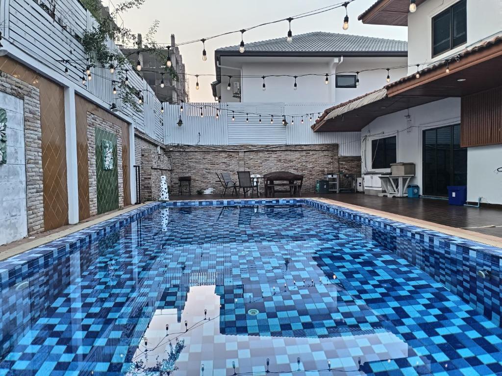 a swimming pool with blue tiles in a house at jomtien 5BR villa in Pattaya South