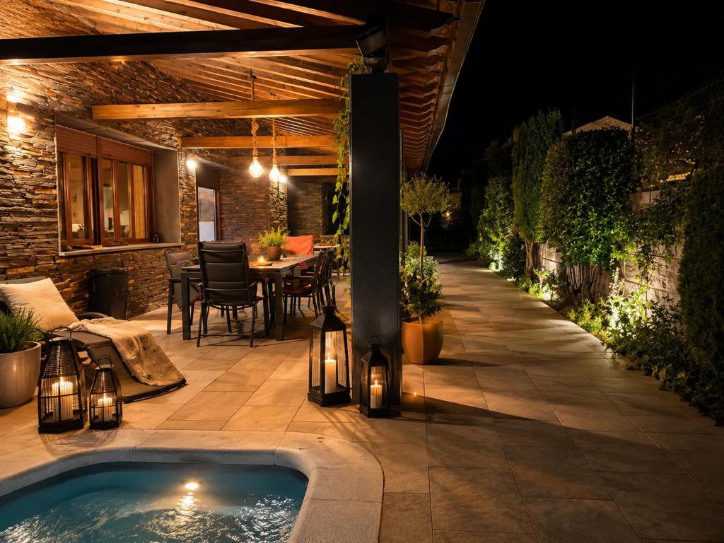 a patio with a swimming pool at night at Vistapeña in Piedrahita