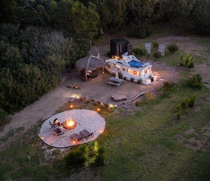an aerial view of a house with lights in a field at Shipwrecked Oasis Ocean Bay Getaway PL in Fingal