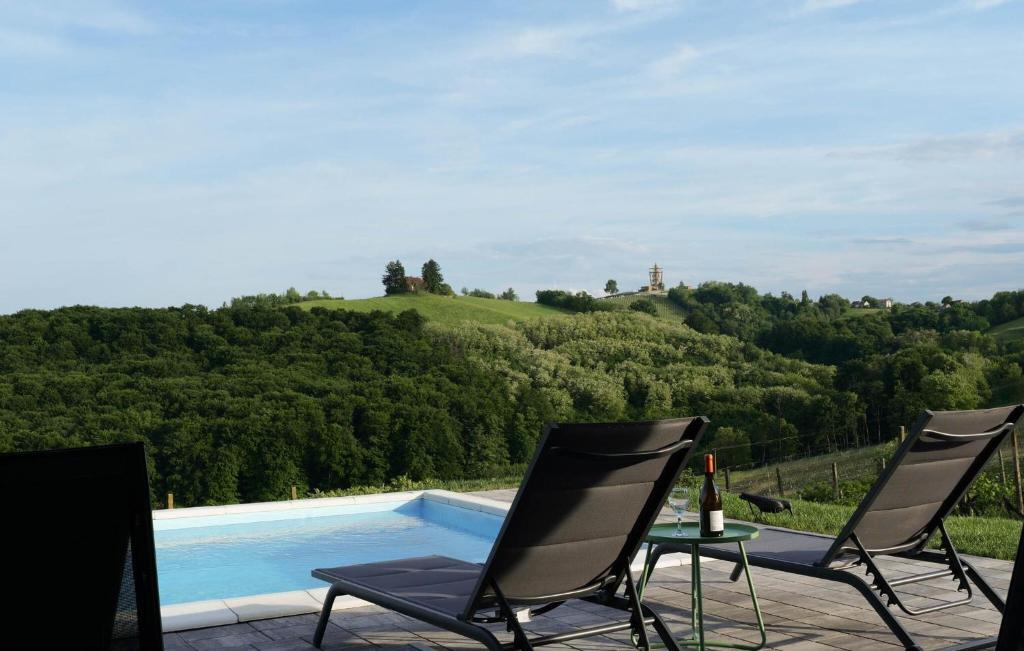 a group of chairs sitting next to a swimming pool at Amazing Home In Banfi in Štrigova
