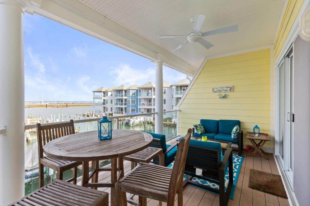 a patio with a table and chairs and a couch at Sunset Bay Villa 209 in Chincoteague