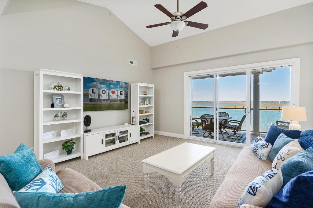 a living room with a couch and a table at Sunset Bay Villa 309 - Changes in Latitude in Chincoteague
