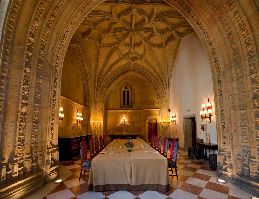 a large dining room with a table and chairs at Parador de Santiago - Hostal Reis Catolicos in Santiago de Compostela