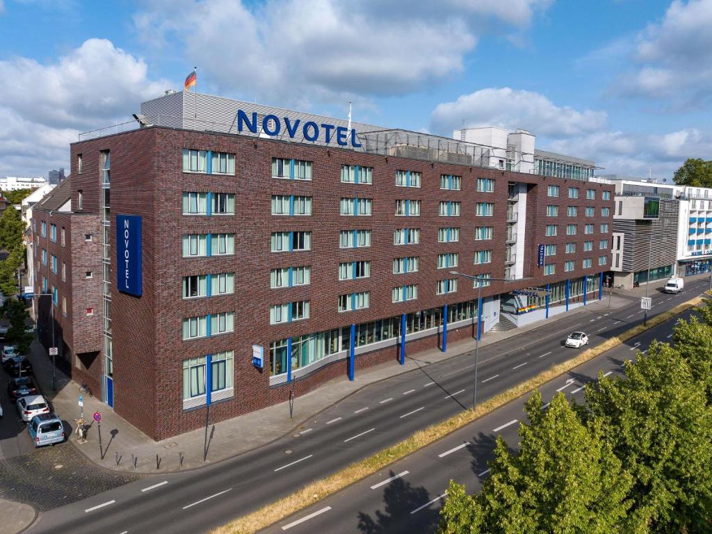 a large red brick building with a sign on it at Novotel Köln City in Cologne